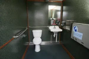 Accessible/Family Washroom with toilet, sink, mirrow and handrails