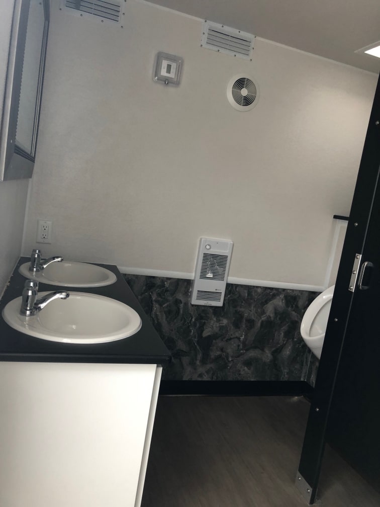 Men's washroom with sink, toilet and mirror