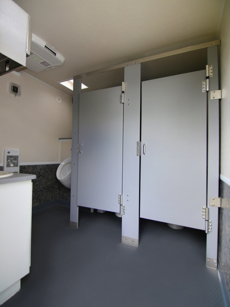 Men's portable washroom with individual stalls and urinal